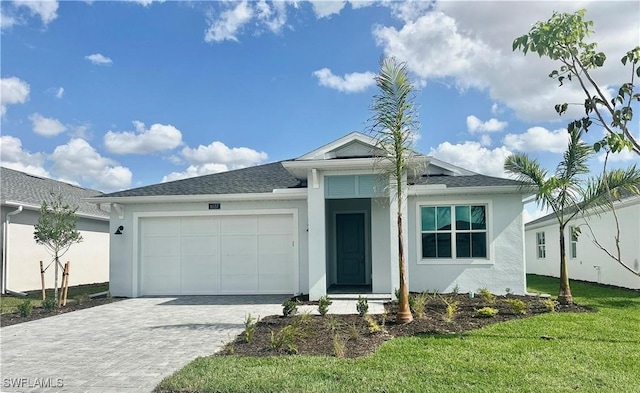 view of front facade featuring a front lawn and a garage