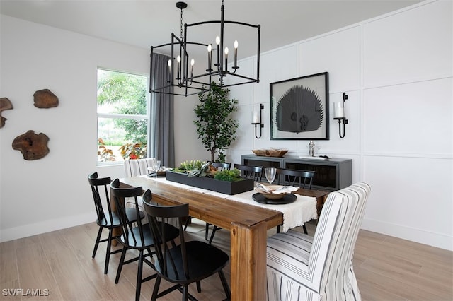 dining area featuring a notable chandelier and light hardwood / wood-style floors