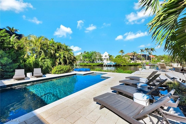 view of swimming pool featuring a patio and a water view