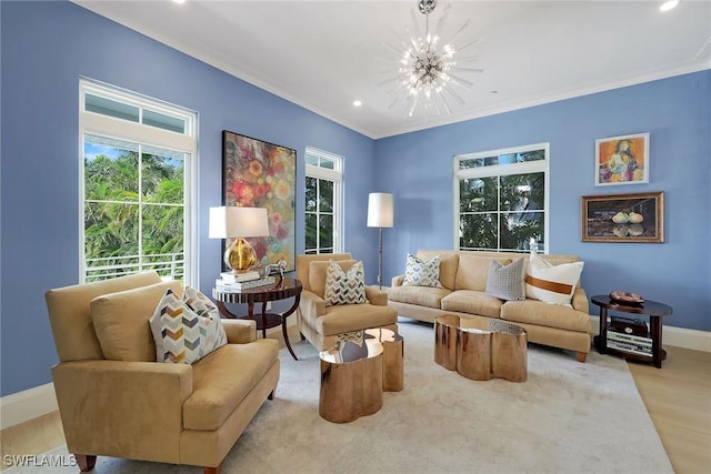 sitting room featuring crown molding, plenty of natural light, light wood-type flooring, and an inviting chandelier