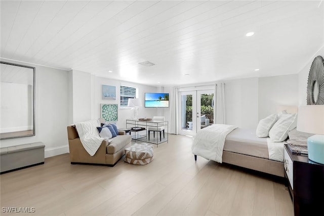 bedroom with french doors, light wood-type flooring, and access to outside