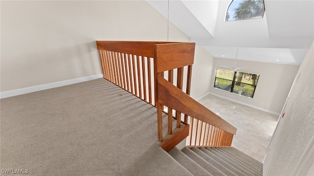 stairs featuring carpet floors, high vaulted ceiling, and ceiling fan