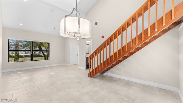 interior space featuring vaulted ceiling and a notable chandelier