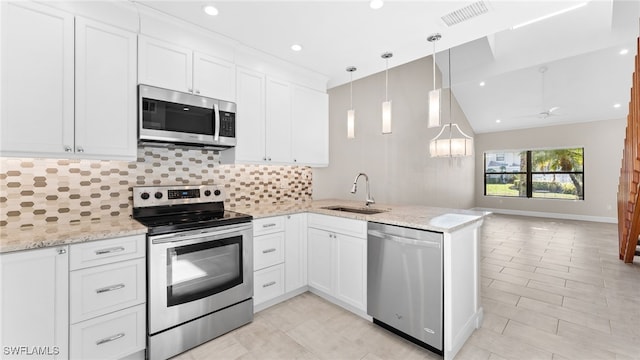 kitchen with white cabinetry, kitchen peninsula, sink, and appliances with stainless steel finishes