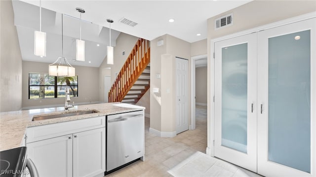 kitchen with dishwasher, white cabinets, sink, light stone countertops, and range