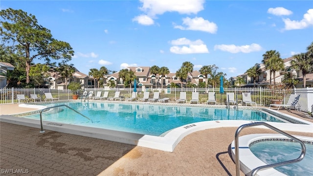 view of pool featuring a community hot tub and a patio area