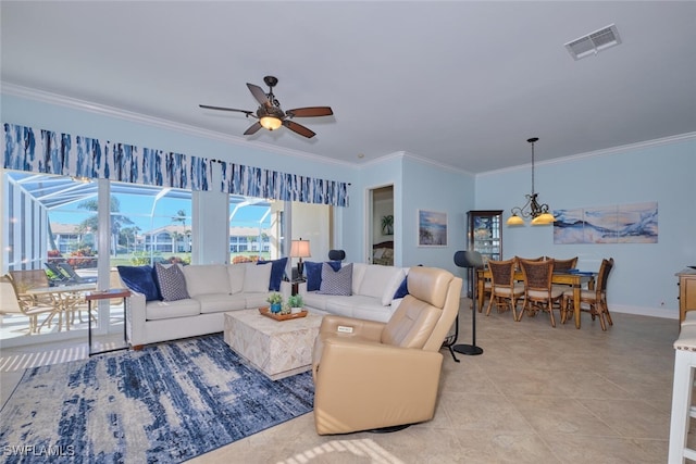 living room featuring crown molding, light tile patterned floors, and ceiling fan with notable chandelier