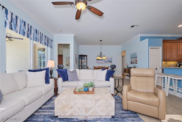 living room with ceiling fan with notable chandelier and crown molding