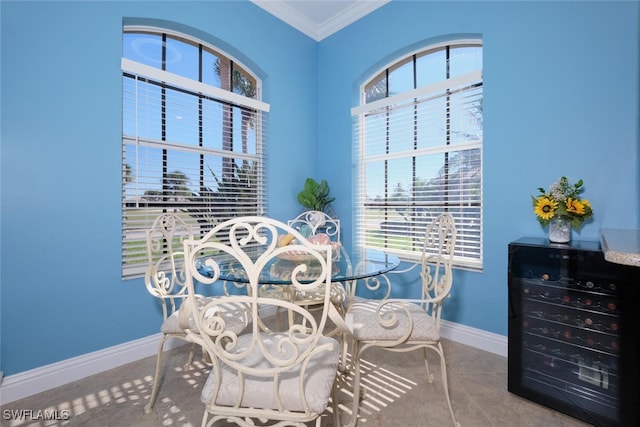 dining space featuring beverage cooler and ornamental molding