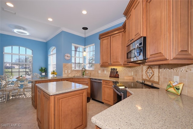 kitchen featuring a healthy amount of sunlight, light stone countertops, and appliances with stainless steel finishes