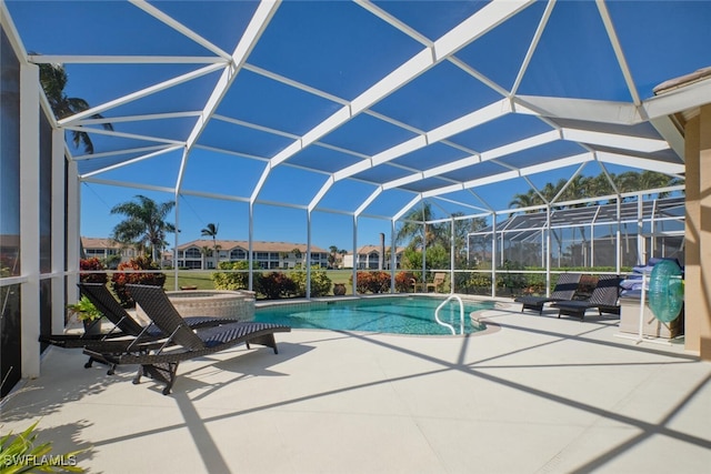 view of swimming pool with a patio and a lanai