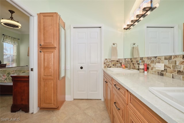 bathroom featuring decorative backsplash, vanity, and tile patterned floors