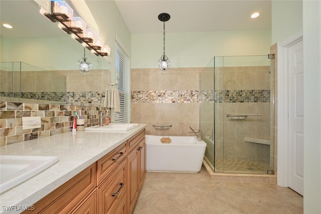 bathroom with tile patterned flooring, shower with separate bathtub, and vanity