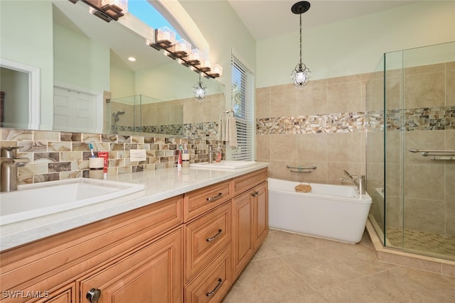 bathroom featuring decorative backsplash, shower with separate bathtub, vanity, and tile patterned floors