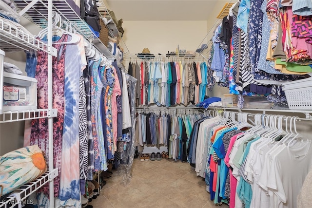 spacious closet with tile patterned floors