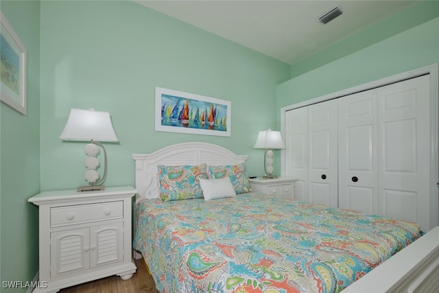 bedroom featuring hardwood / wood-style floors and a closet