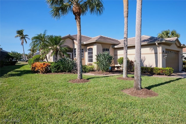 ranch-style home featuring a front lawn and a garage