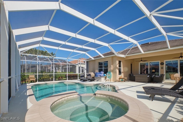 view of pool with outdoor lounge area, glass enclosure, ceiling fan, an in ground hot tub, and a patio