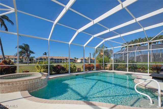 view of swimming pool with glass enclosure and an in ground hot tub