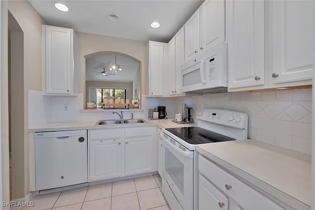 kitchen with white appliances, white cabinetry, ceiling fan, and sink