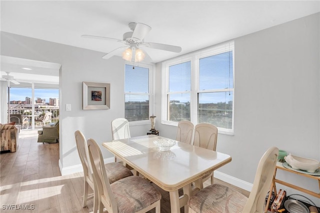 dining space featuring ceiling fan, a wealth of natural light, and light hardwood / wood-style flooring