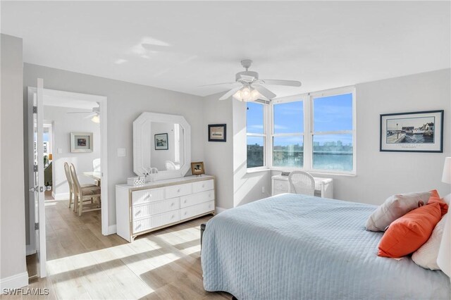 bedroom with ceiling fan and light hardwood / wood-style floors