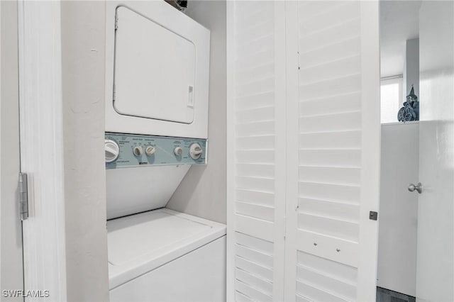 laundry room with stacked washer and clothes dryer