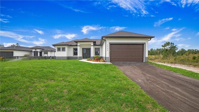 view of front of property with a front yard and a garage