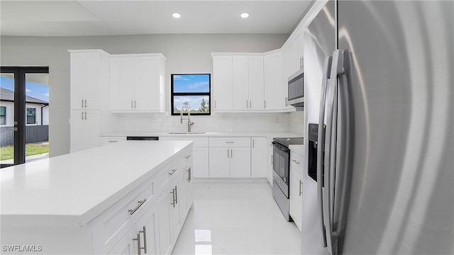 kitchen with plenty of natural light, a center island, and appliances with stainless steel finishes