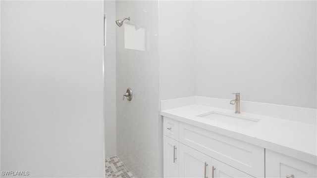 bathroom featuring a tile shower and vanity