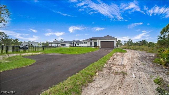 ranch-style house featuring a front yard and a garage