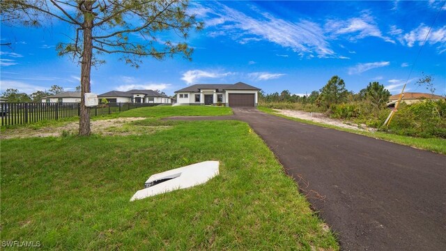 view of front of home with a garage and a front yard