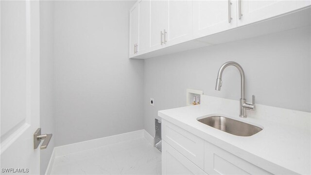 clothes washing area featuring hookup for an electric dryer, washer hookup, cabinets, and sink