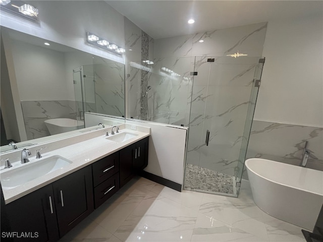 bathroom with shower with separate bathtub, vanity, and tile walls