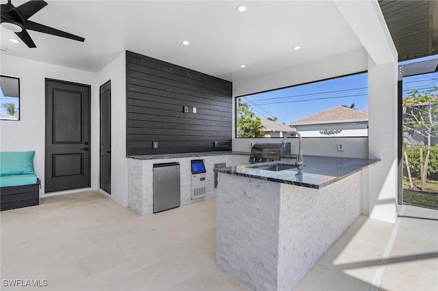 view of patio / terrace with ceiling fan, area for grilling, sink, and a grill