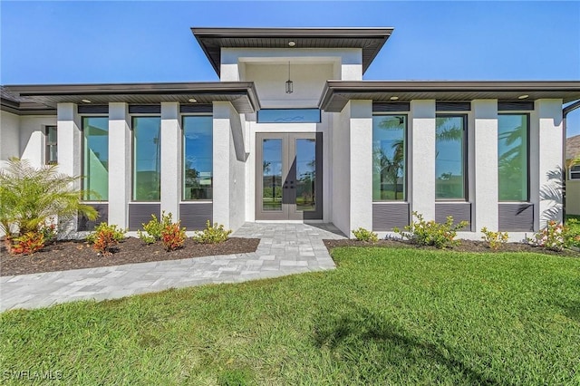 back of property with french doors and a yard