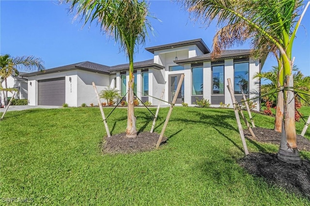 2123 SW 52nd Ter, Cape Coral, FL 33914 - view of front of property with stucco siding, a garage, a front yard, and driveway