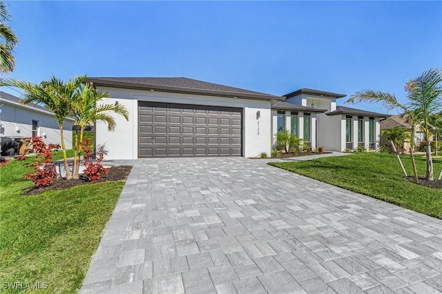 2123 SW 52nd Ter, Cape Coral, FL 33914 - prairie-style home with decorative driveway, a garage, a front yard, and stucco siding