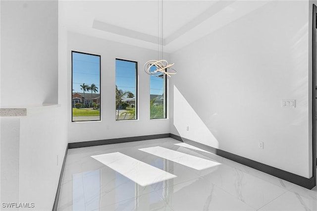 2123 SW 52nd Ter, Cape Coral, FL 33914 - empty room featuring a chandelier and a raised ceiling