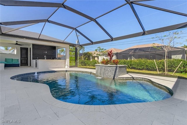 view of swimming pool with a lanai, a patio area, pool water feature, and ceiling fan