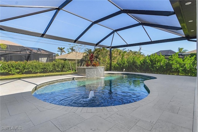 view of pool featuring pool water feature, glass enclosure, and a patio area