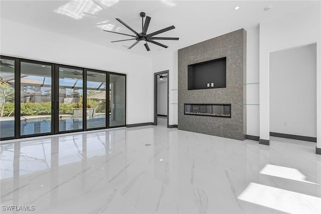 unfurnished living room with ceiling fan and a fireplace