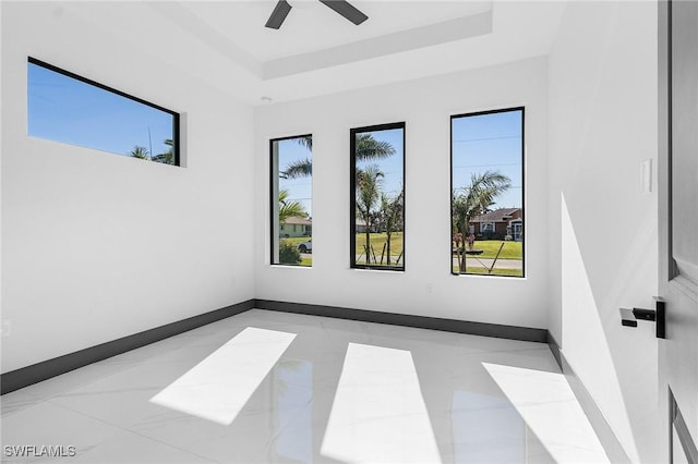 unfurnished room with a tray ceiling and ceiling fan