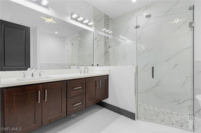 bathroom featuring vanity and a shower with door