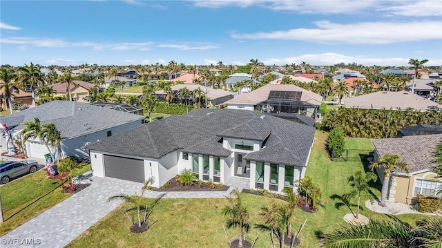 2123 SW 52nd Ter, Cape Coral, FL 33914 - view of front of property featuring a residential view, a garage, decorative driveway, stucco siding, and a shingled roof