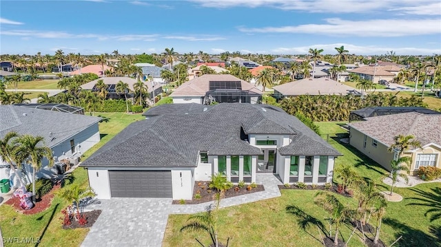 2123 SW 52nd Ter, Cape Coral, FL 33914 - view of front facade with a residential view, a garage, stucco siding, decorative driveway, and a front yard