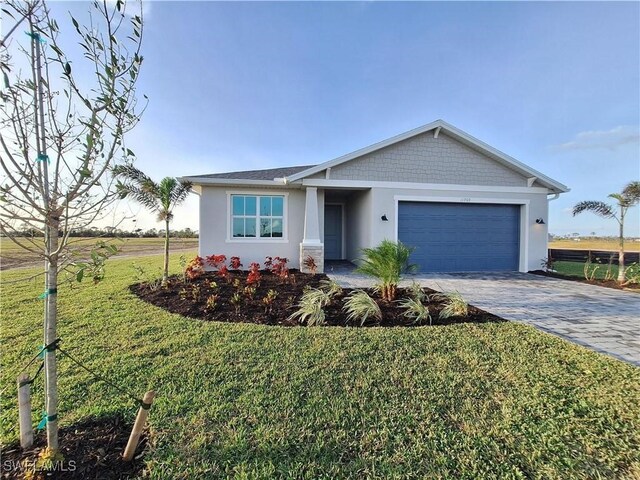 ranch-style home with a garage and a front lawn