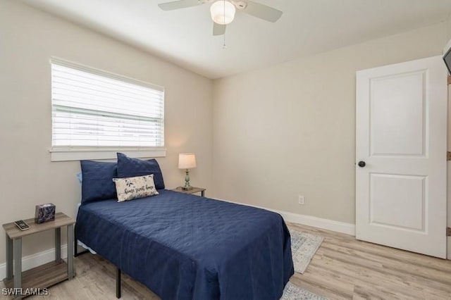 bedroom with ceiling fan and light hardwood / wood-style flooring