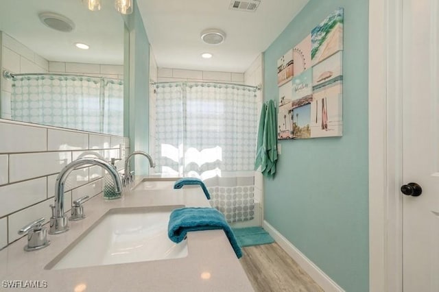 bathroom with hardwood / wood-style floors, a shower with curtain, and vanity