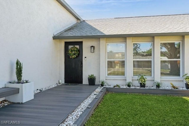 entrance to property featuring a yard